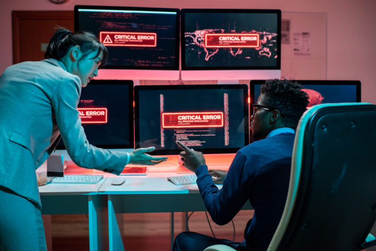Two young intercultural programmers trying to solve problem with access to data